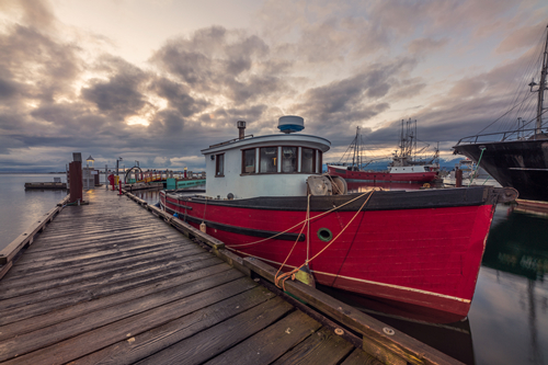 red-and-white-boat-on-dock-under-cloudy-sky-3989770.jpg